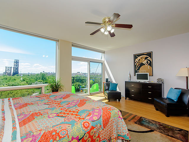 61 West 15th Street, Unit 607 Chicago, IL 60605 - Photo 10 of 23 a bedroom with a bed and a chandelier
