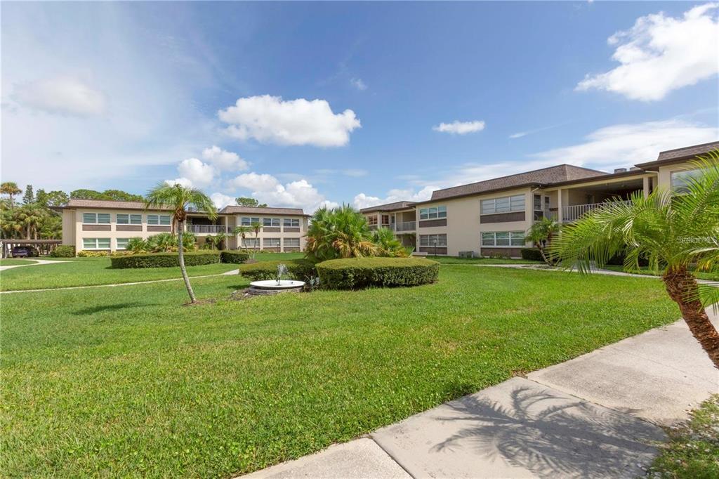 4557 Garnet Drive, Unit 102 New Port Richey, FL 34652 - Photo 3 of 14 a view of a house with a backyard
