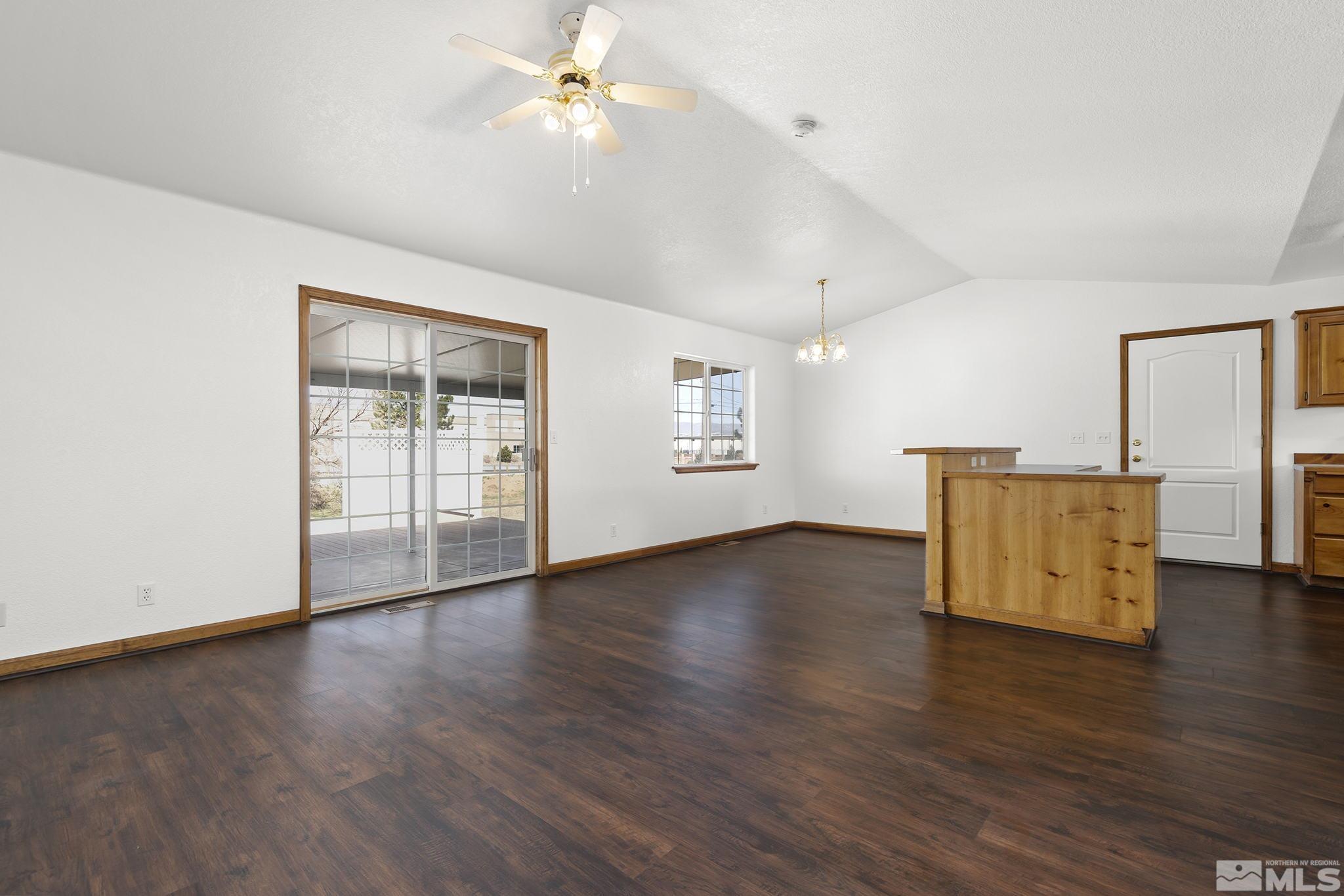 8545 Gate Street Reno, NV 89506 - Photo 4 of 29 a view of an empty room with wooden floor and a window