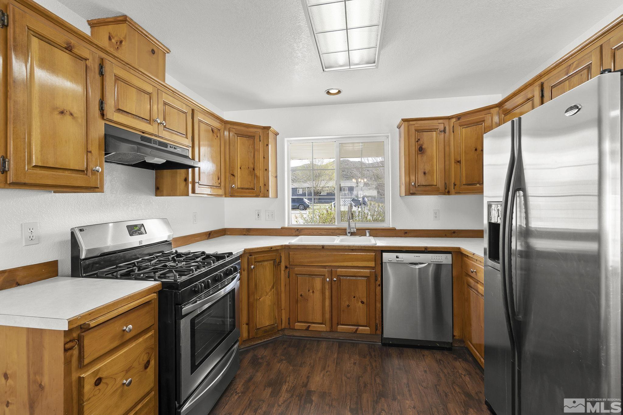 8545 Gate Street Reno, NV 89506 - Photo 9 of 29 a kitchen with stainless steel appliances granite countertop a stove and a refrigerator