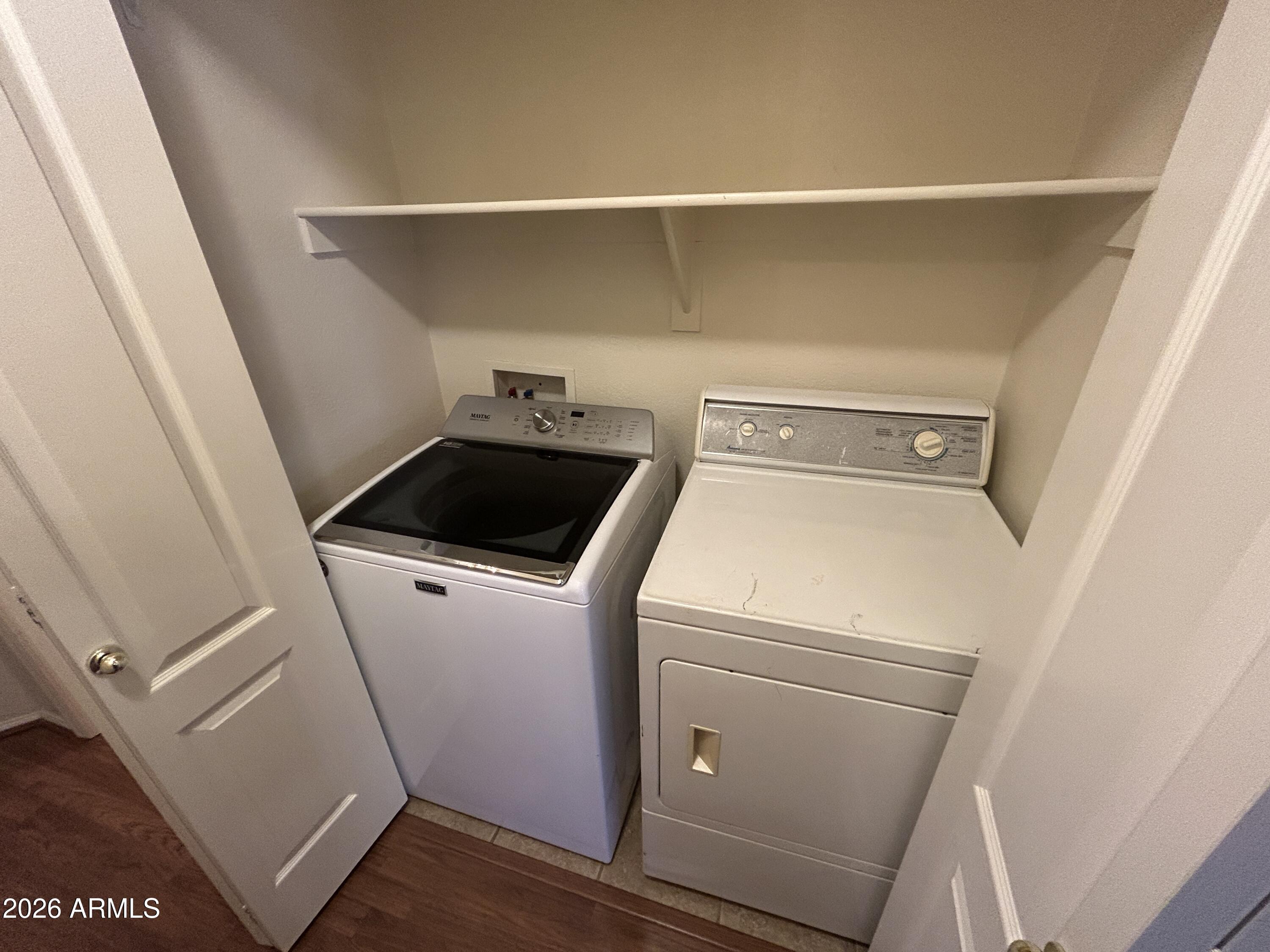 15948 West Latham Street Goodyear, AZ 85338 - Photo 12 of 14 a utility room with dryer and washer
