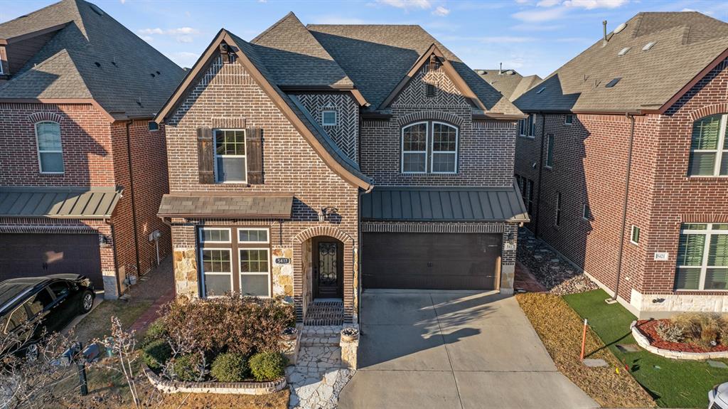 a view of a white house with many windows and a yard