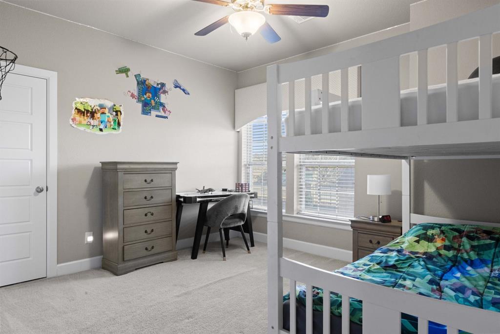 5417 Harbour Road Richardson, TX 75082 - Photo 11 of 23 a bedroom with a bed and ceiling fan