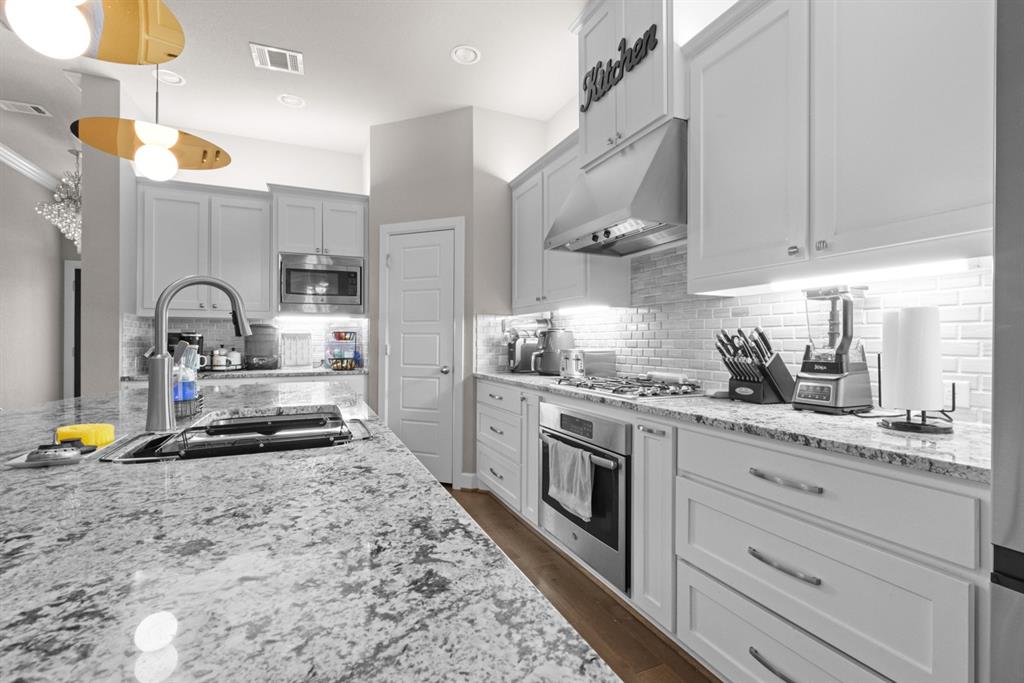 5417 Harbour Road Richardson, TX 75082 - Photo 6 of 23 a kitchen with granite countertop a sink stainless steel appliances and cabinets