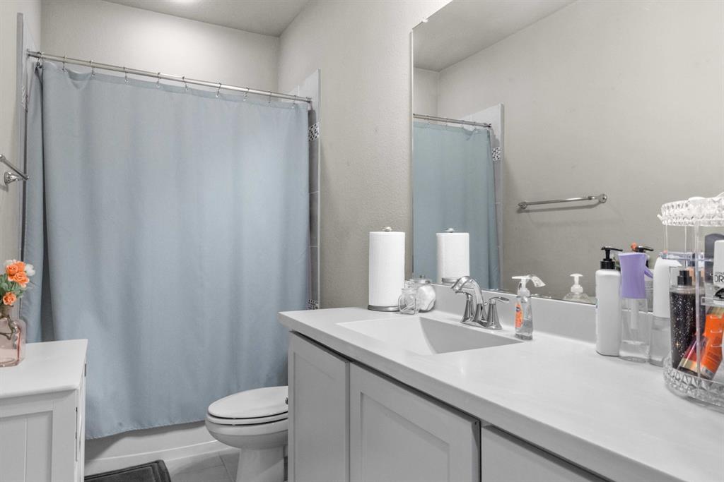 5417 Harbour Road Richardson, TX 75082 - Photo 9 of 23 a bathroom with a sink a toilet and shower curtain