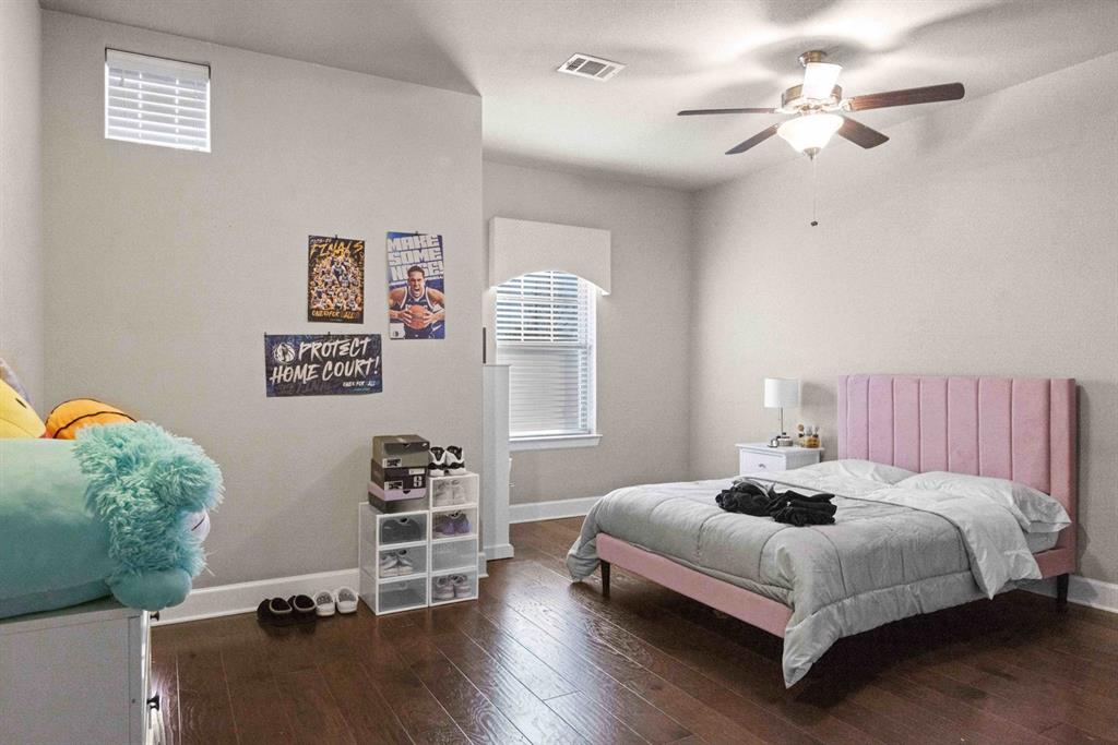 5417 Harbour Road Richardson, TX 75082 - Photo 10 of 23 a bedroom with a bed chandelier and a window