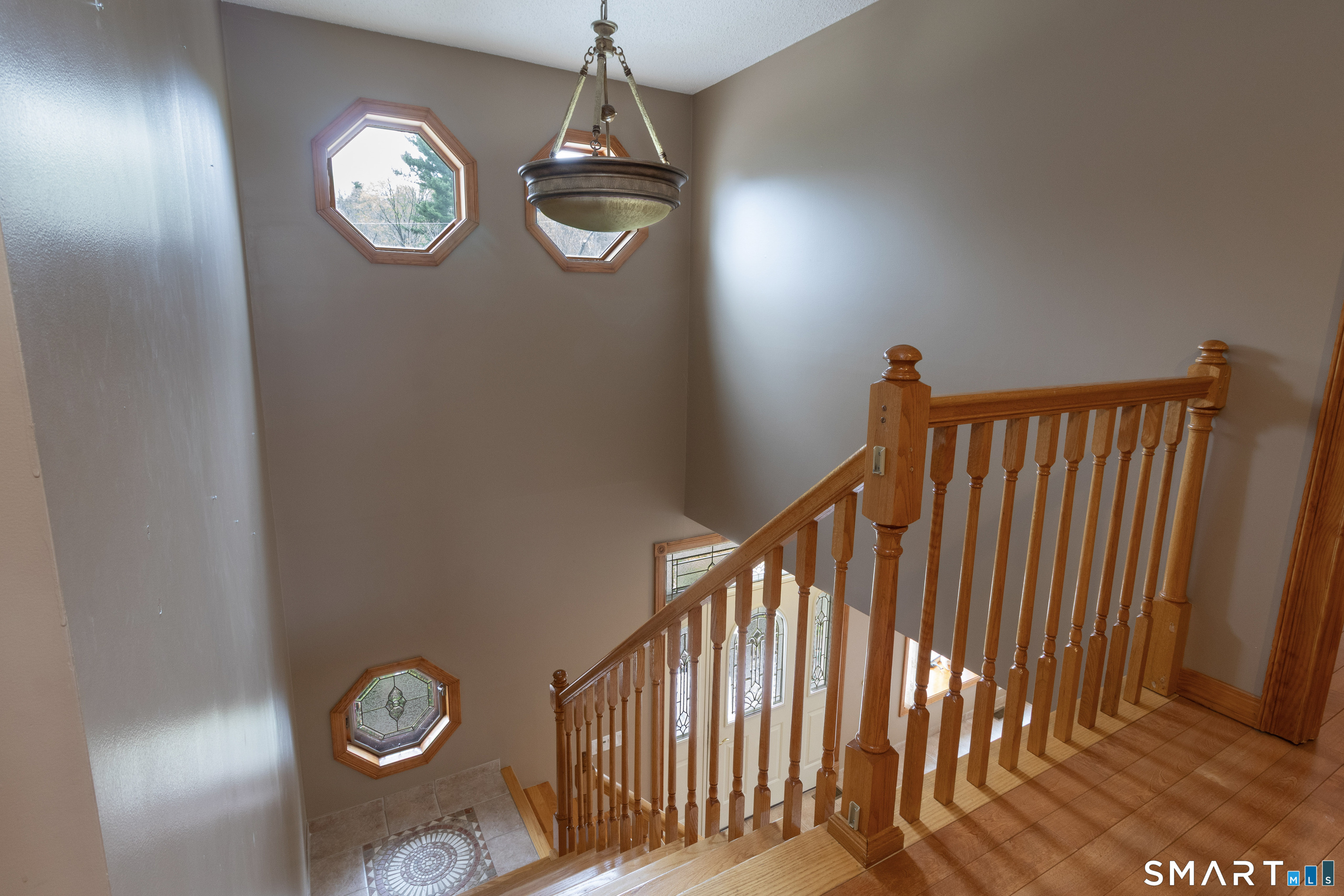 113 Pinnacle Road Plainville, CT 06062 - Photo 19 of 36 Grand staircase with tiled mosaic landing