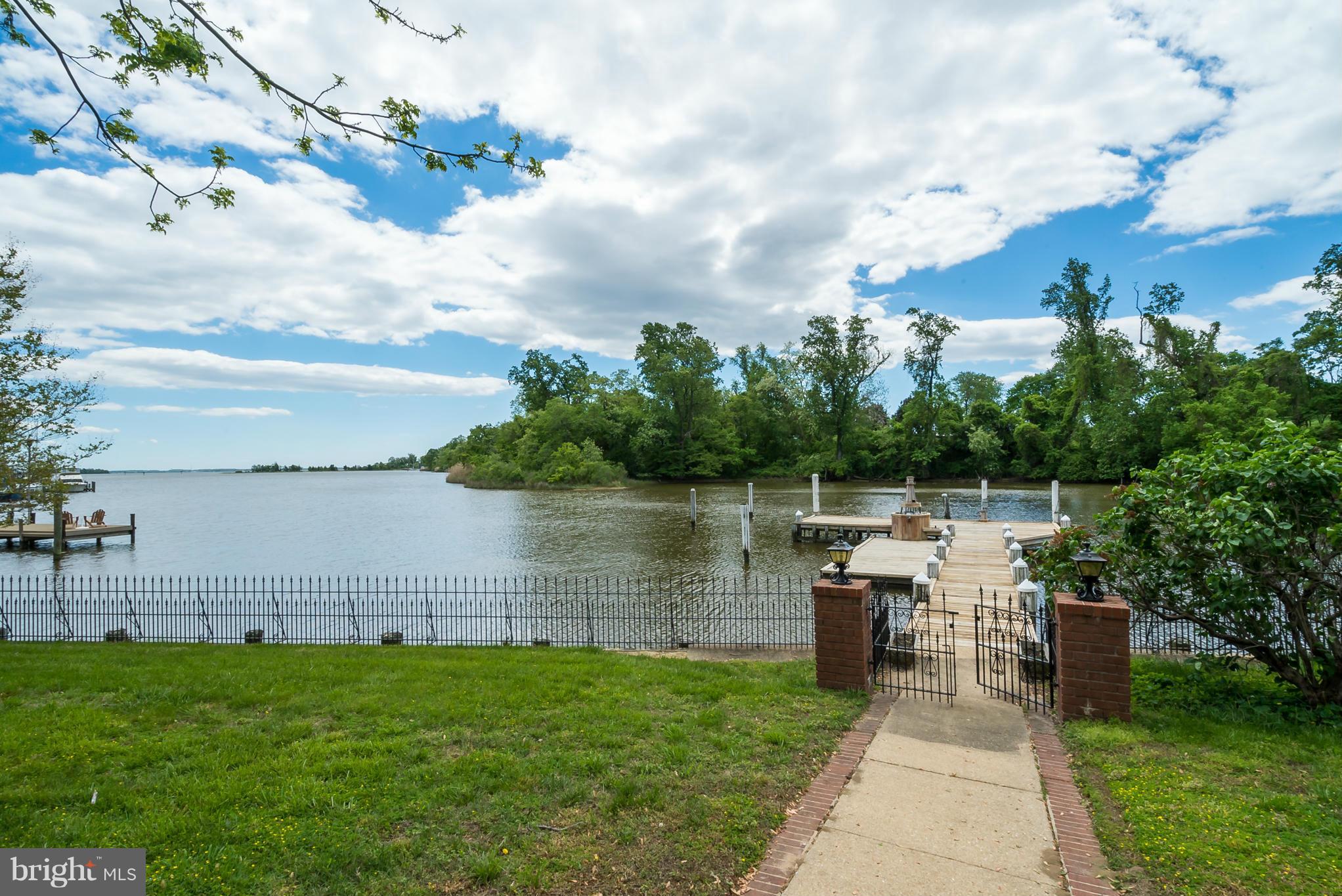 254 Providence Road Annapolis, MD 21409 - Photo 5 of 5 a backyard of a house with lots of green space and lake view in back