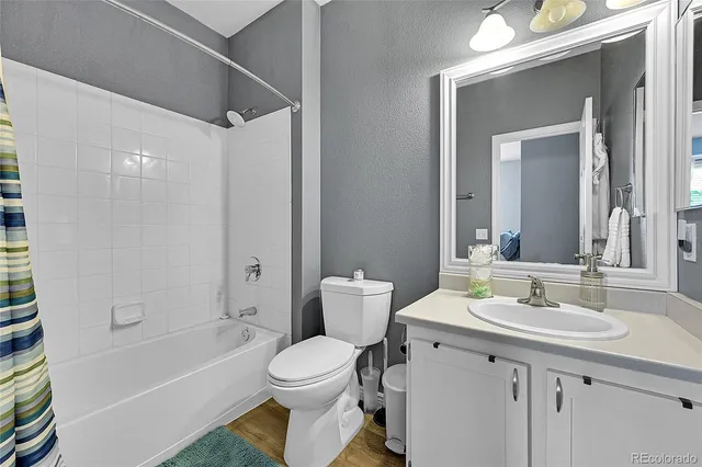 a view of a balcony with wooden floor and fence