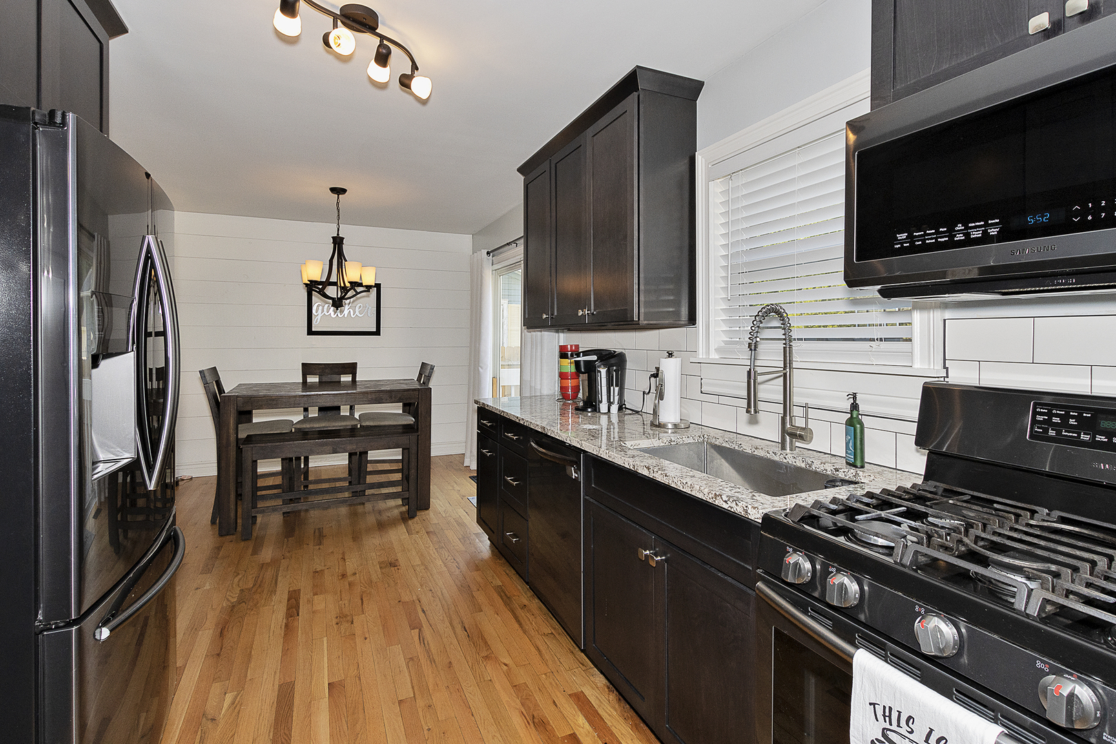 26276 West Rollins Road Ingleside, IL 60041 - Photo 8 of 28 a kitchen with stainless steel appliances a stove sink microwave and cabinets