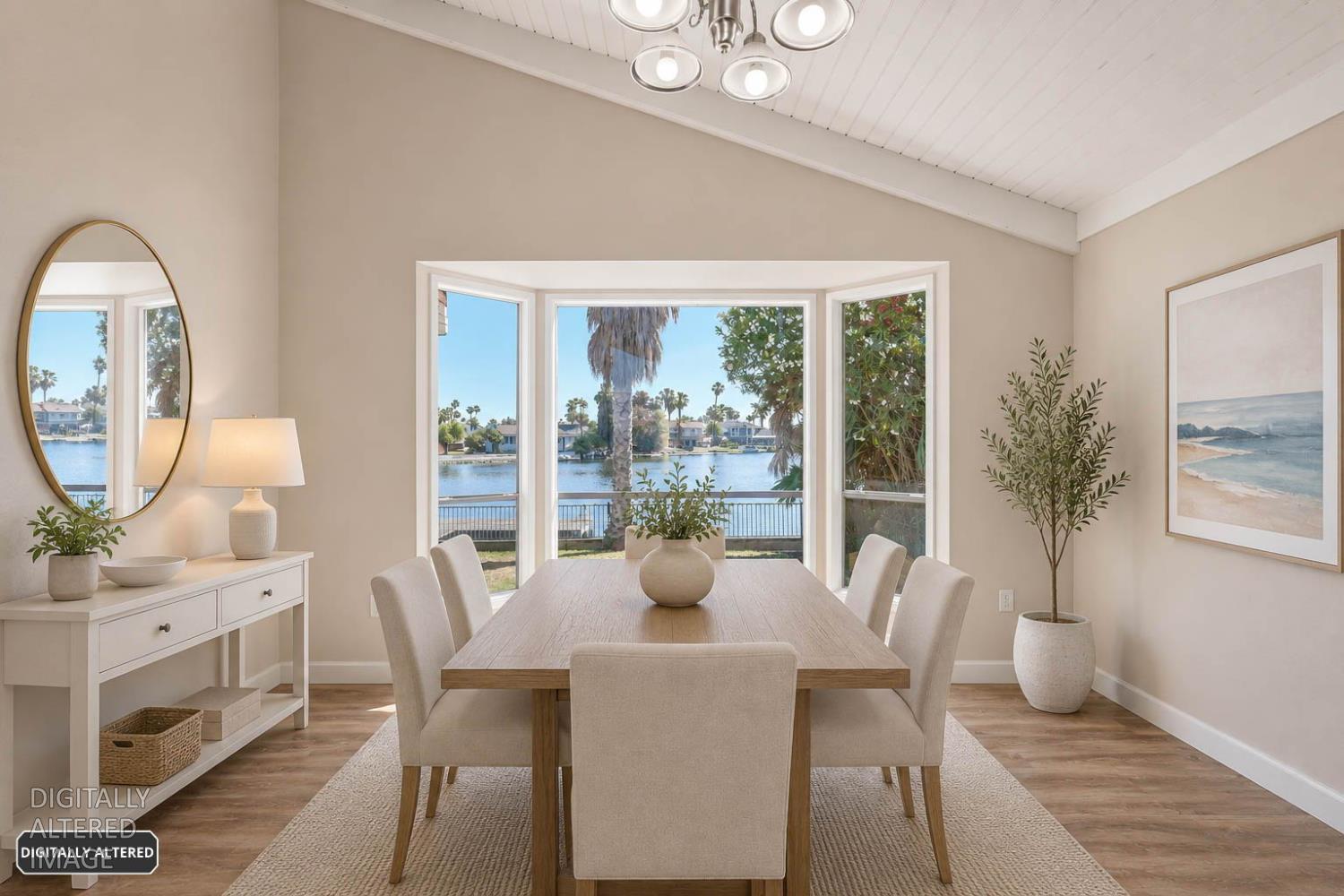 5501 Riverlake Road Discovery Bay, CA 94505 - Photo 14 of 60 a dining room with furniture potted plants and wooden floor