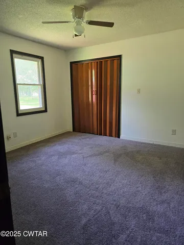 a view of a wooden house with a yard