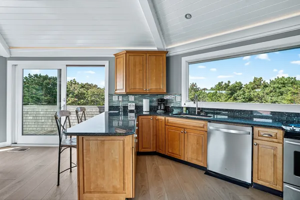a kitchen with stainless steel appliances granite countertop a stove a sink and a refrigerator