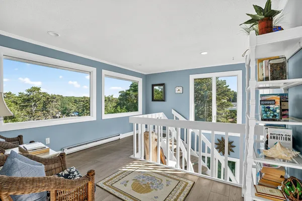 a living room with furniture and a floor to ceiling window