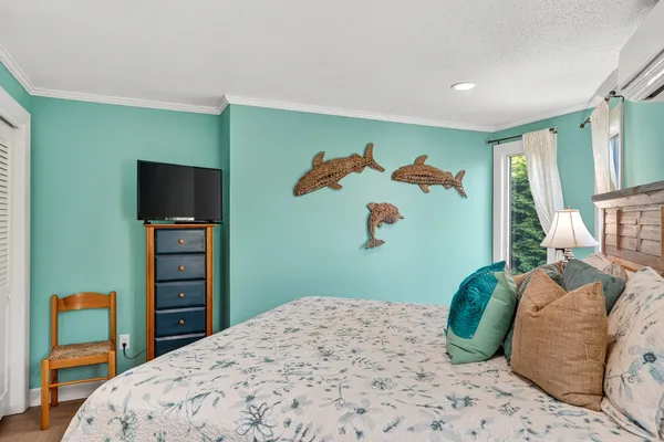 a bedroom with a bed and a television