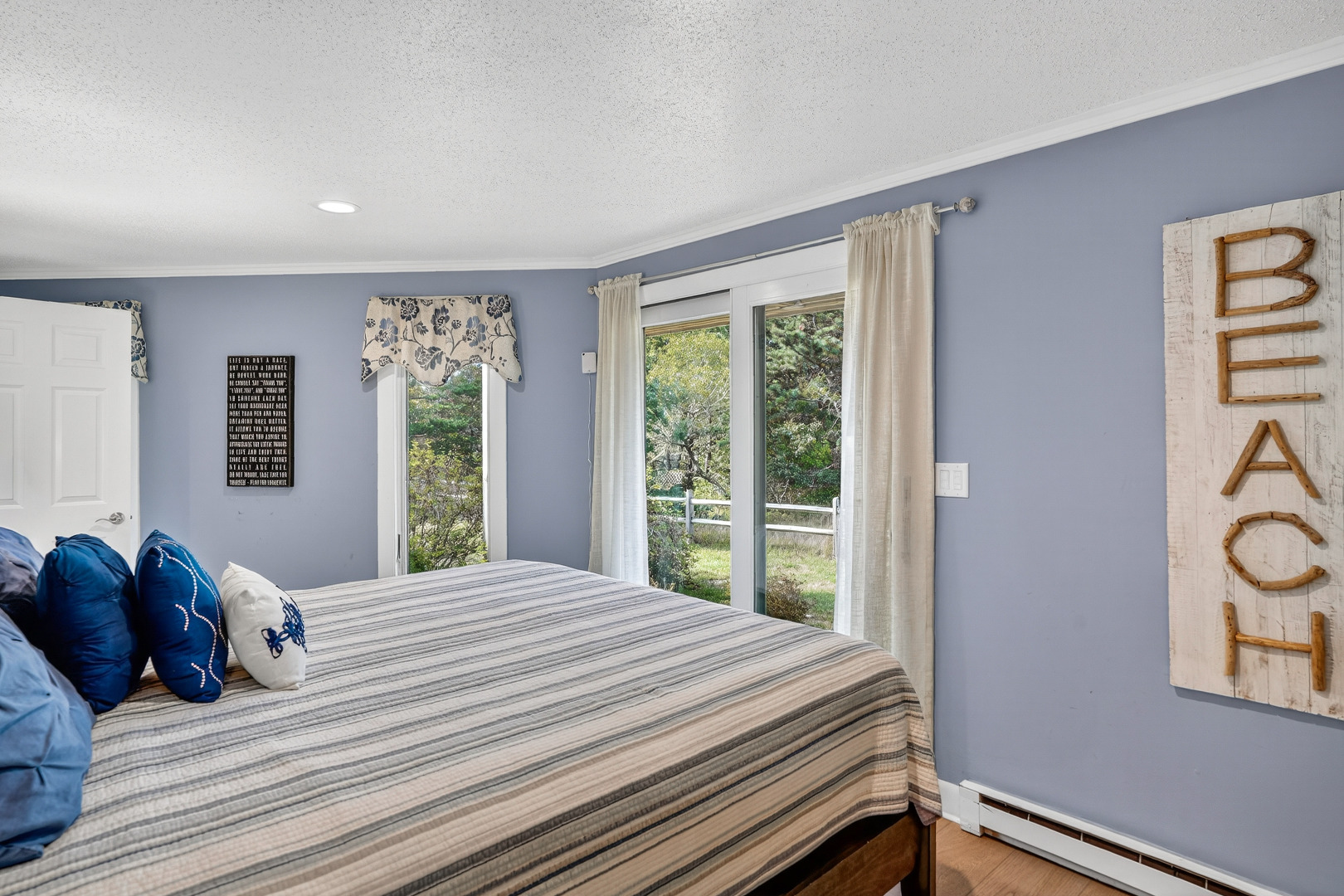 76 Washque Avenue Edgartown, MA 02539 - Photo 39 of 50 a bedroom with a bed and a large window
