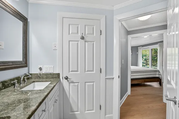 a bathroom with a granite countertop sink and a mirror