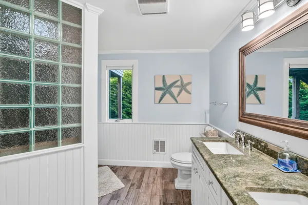 a bathroom with a granite countertop sink a mirror and a window