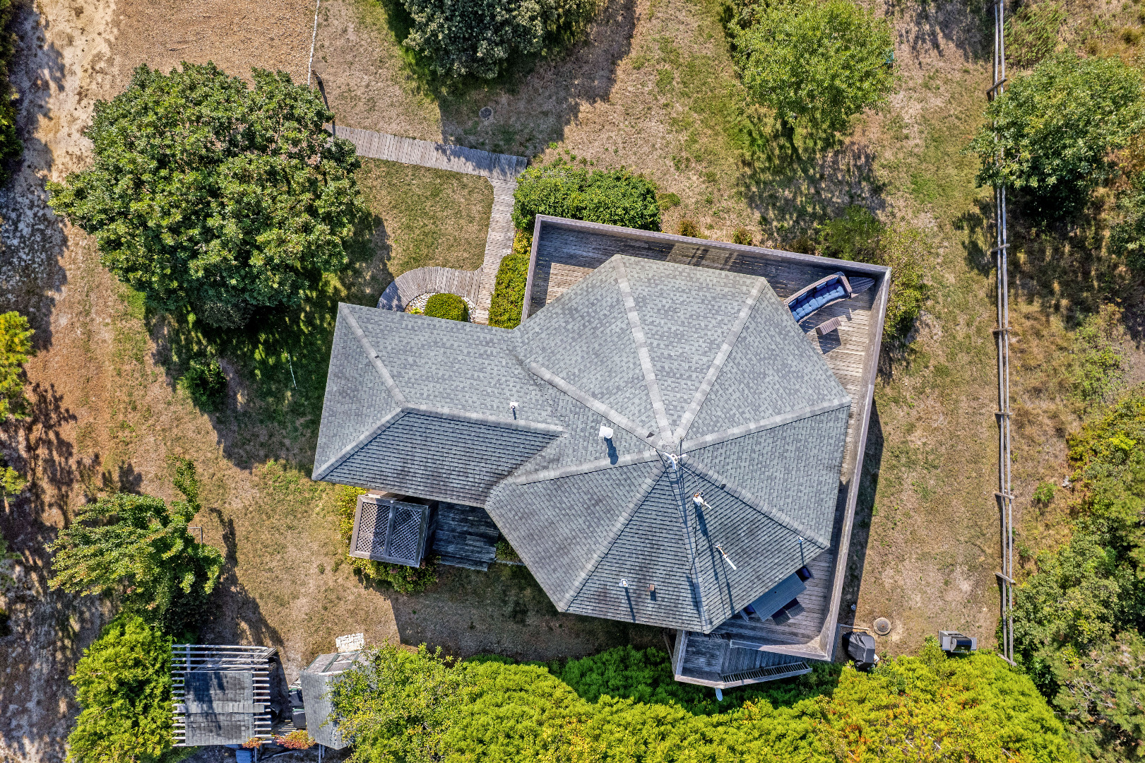 76 Washque Avenue Edgartown, MA 02539 - Photo 6 of 50 an aerial view of a house with roof deck and table under an umbrella