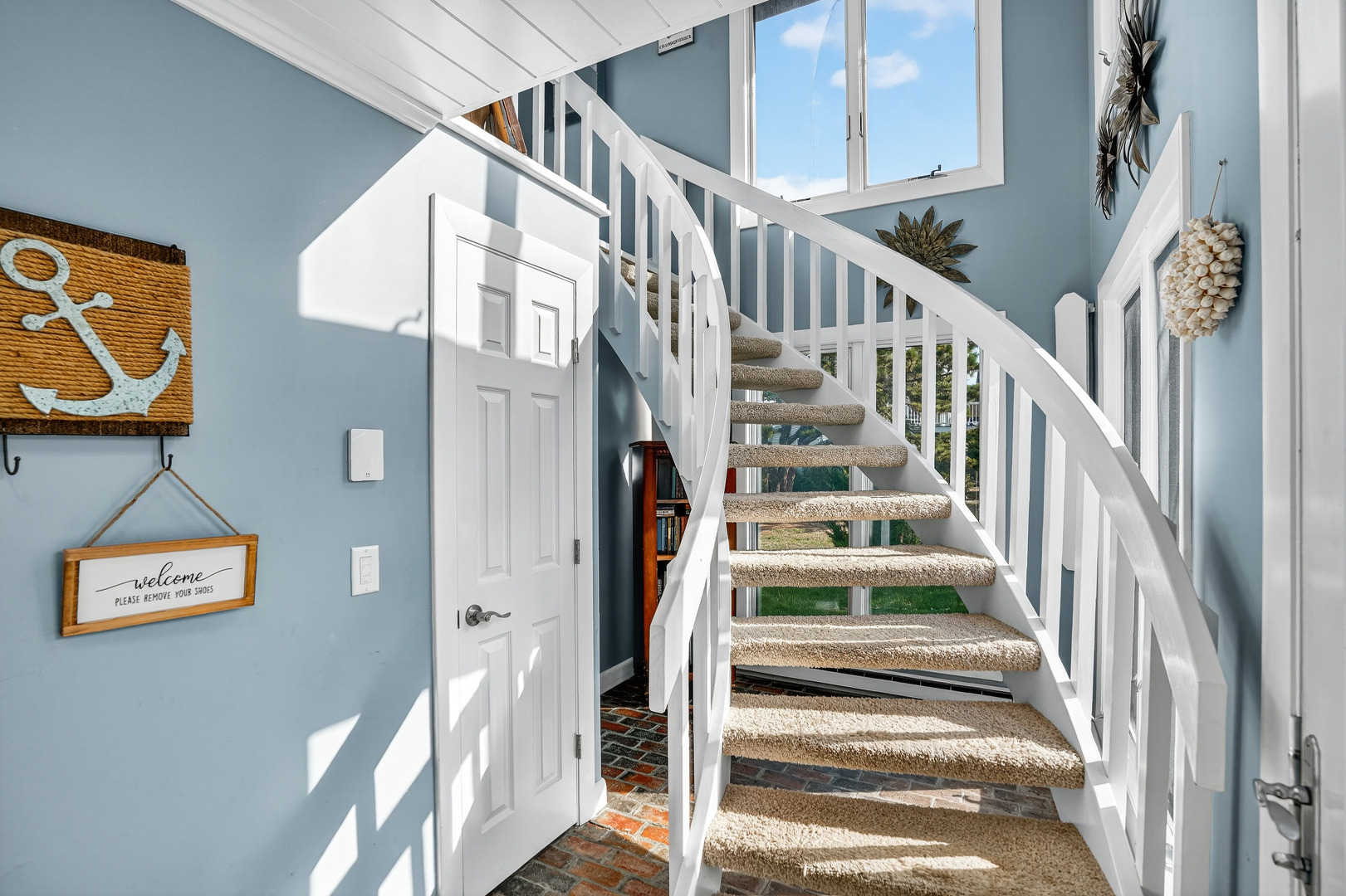 76 Washque Avenue Edgartown, MA 02539 - Photo 10 of 50 a view of staircase with lots of frames on wall and a window