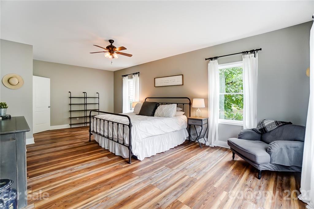 339 Lancaster Estate Road Indian Land, SC 29707 - Photo 19 of 48 a bedroom with a bed and wooden floor