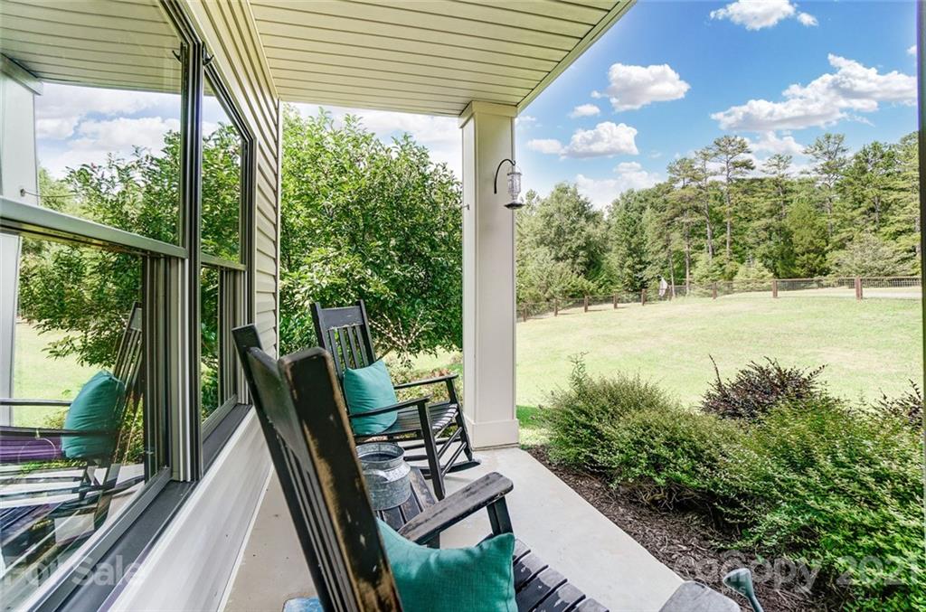 339 Lancaster Estate Road Indian Land, SC 29707 - Photo 3 of 48 a view of a balcony with chair and wooden floor