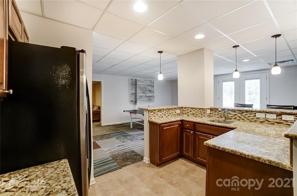 339 Lancaster Estate Road Indian Land, SC 29707 - Photo 31 of 48 a kitchen with a sink a counter top space and stainless steel appliances