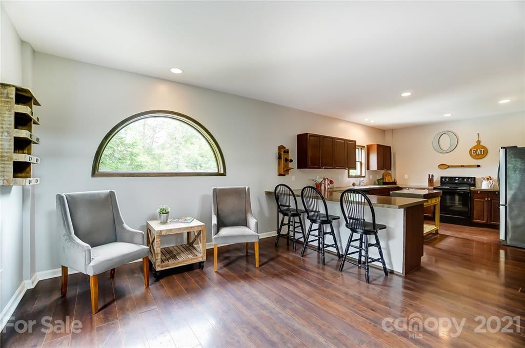 339 Lancaster Estate Road Indian Land, SC 29707 - Photo 10 of 48 a living room with furniture a dining table and chairs with wooden floor