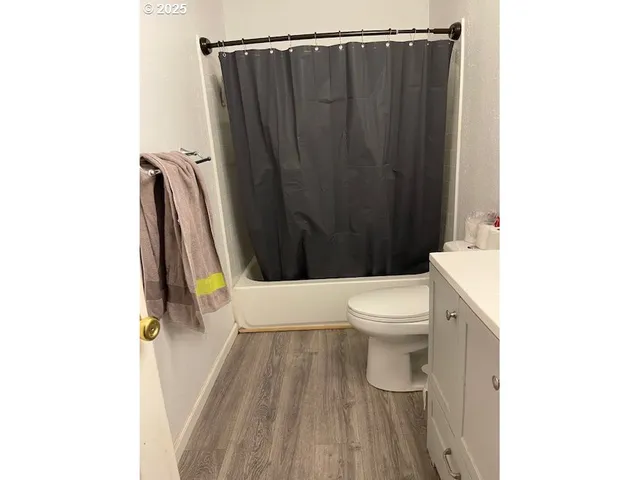 a bathroom with a toilet a sink and a shower