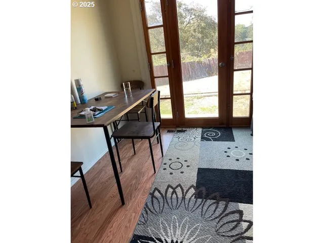 a balcony with table and chairs