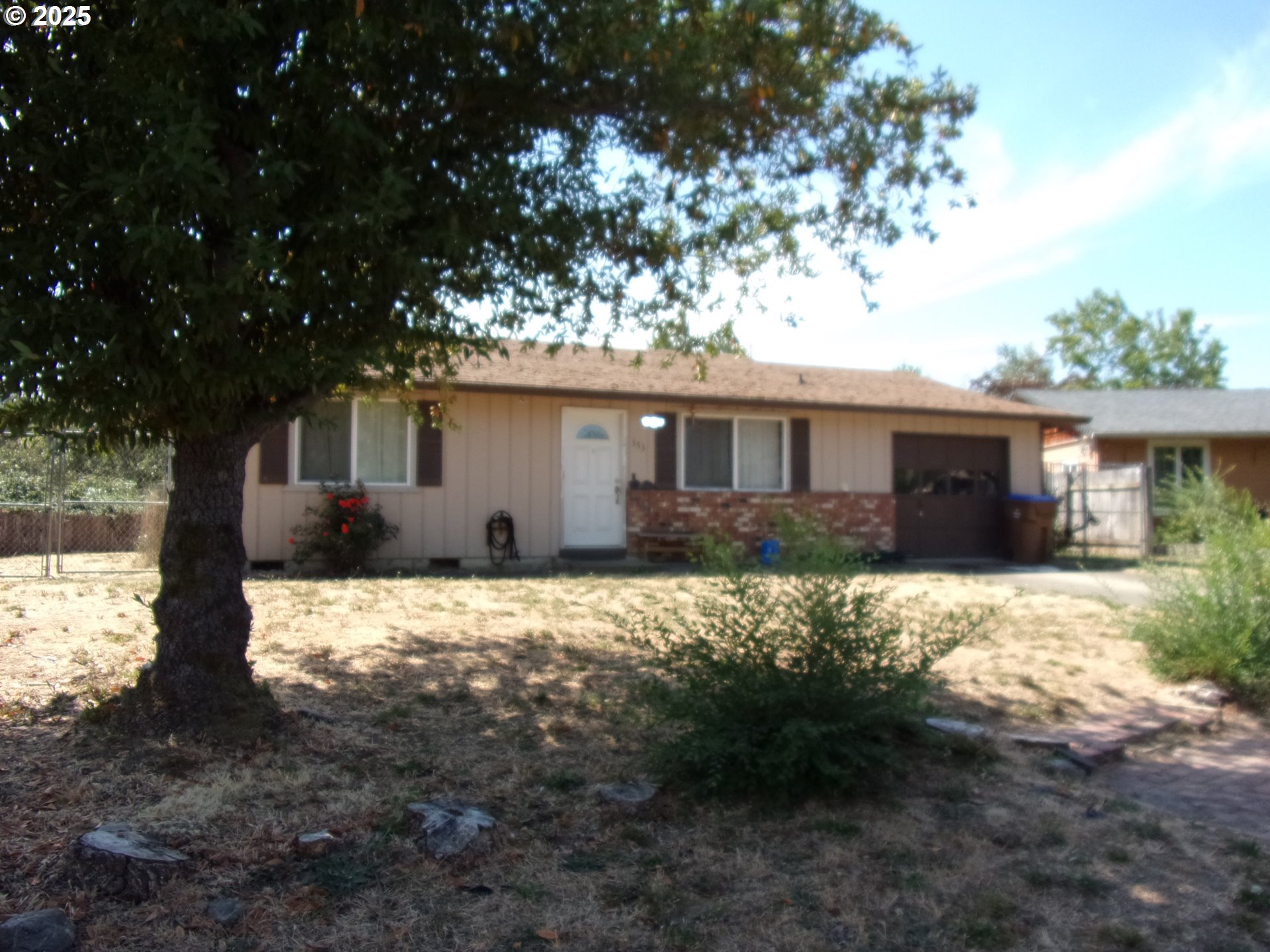 353 Donald Terrace Myrtle Creek, OR 97457 - Photo 2 of 18 a front view of house with yard and trees in the background