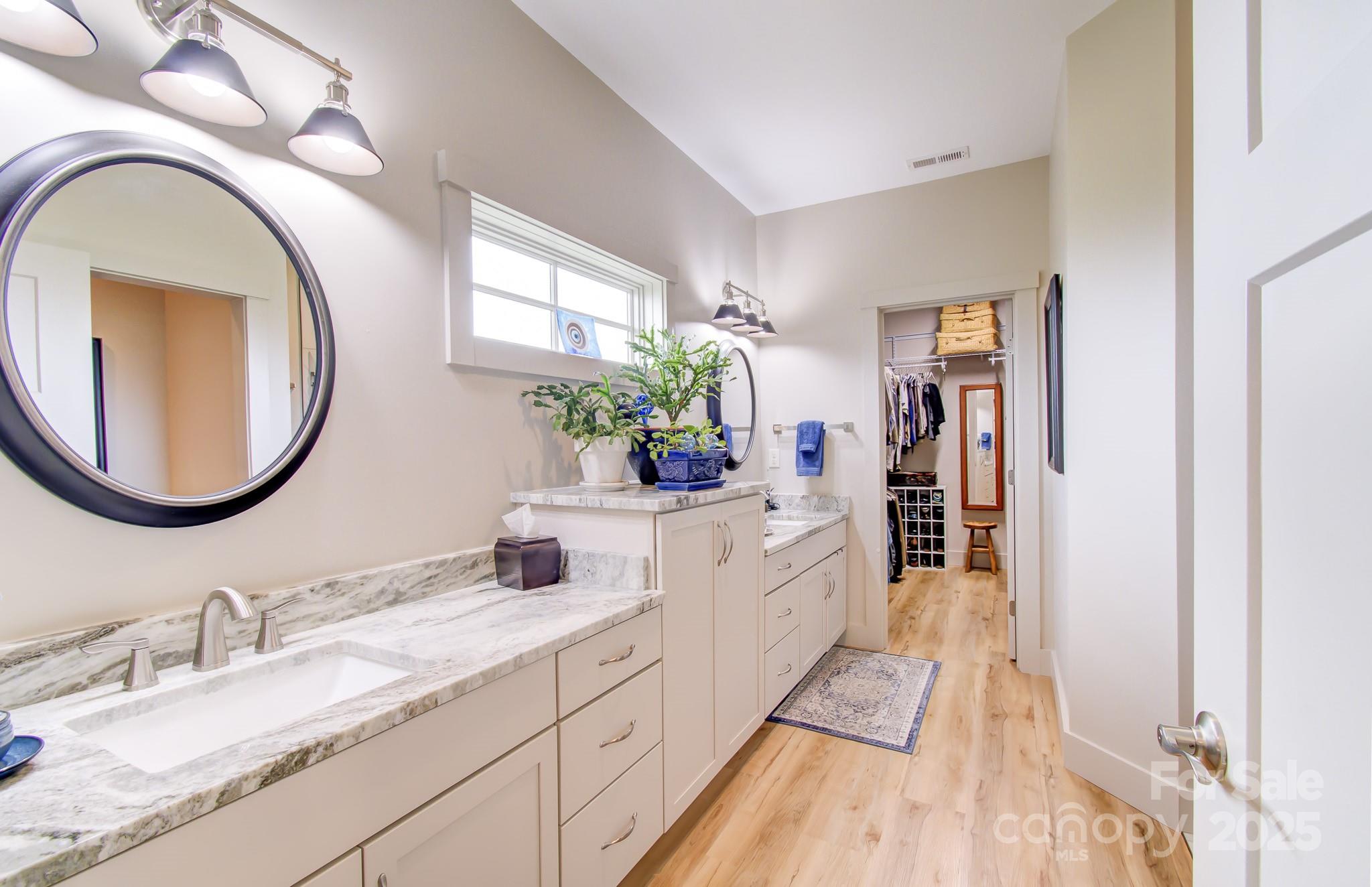 147 Majestic Ridge Road Mills River, NC 28759 - Photo 22 of 48 a spacious bathroom with a granite countertop double vanity sink and a mirror