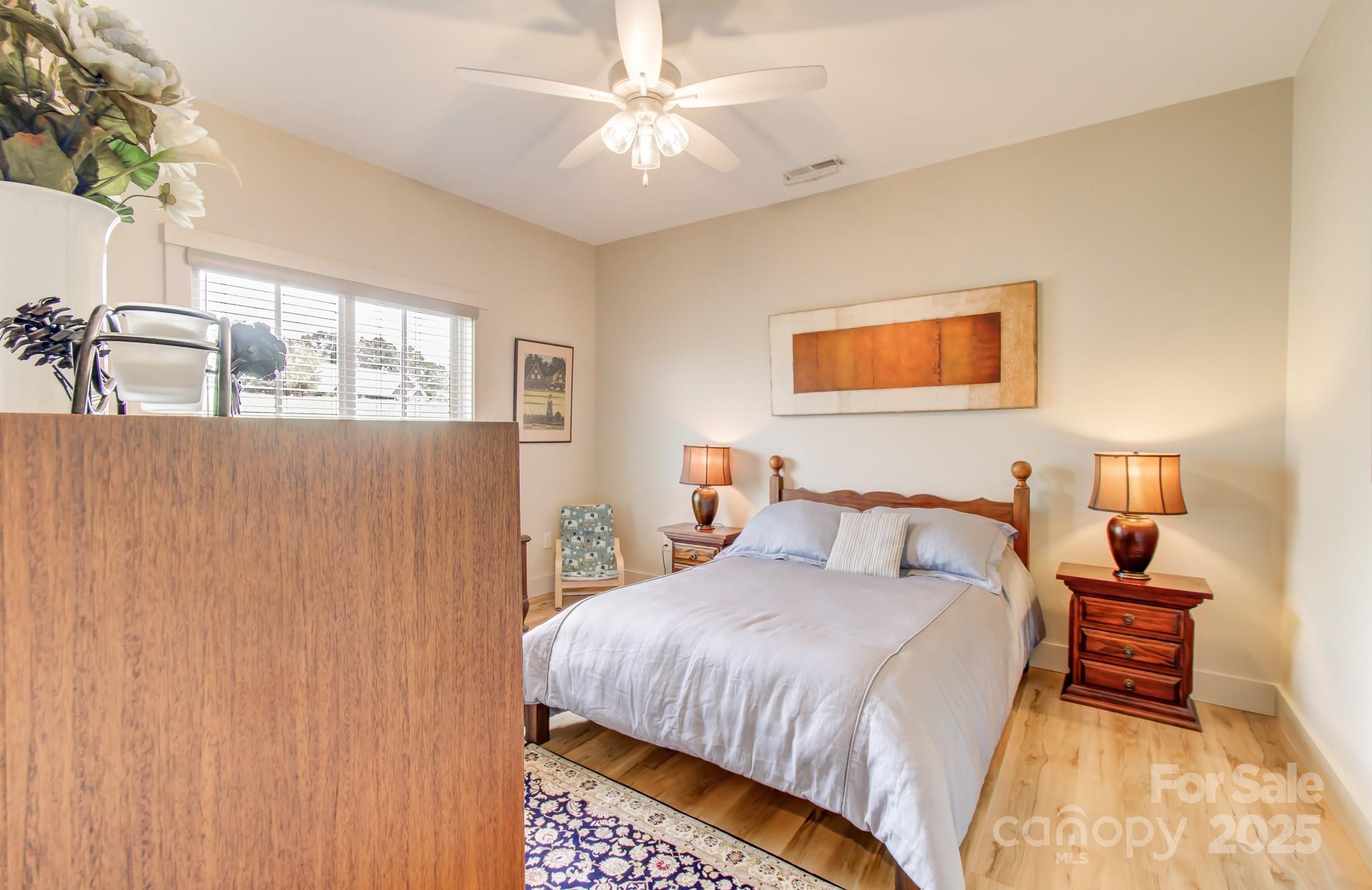 147 Majestic Ridge Road Mills River, NC 28759 - Photo 26 of 48 a bedroom with a bed and a chandelier