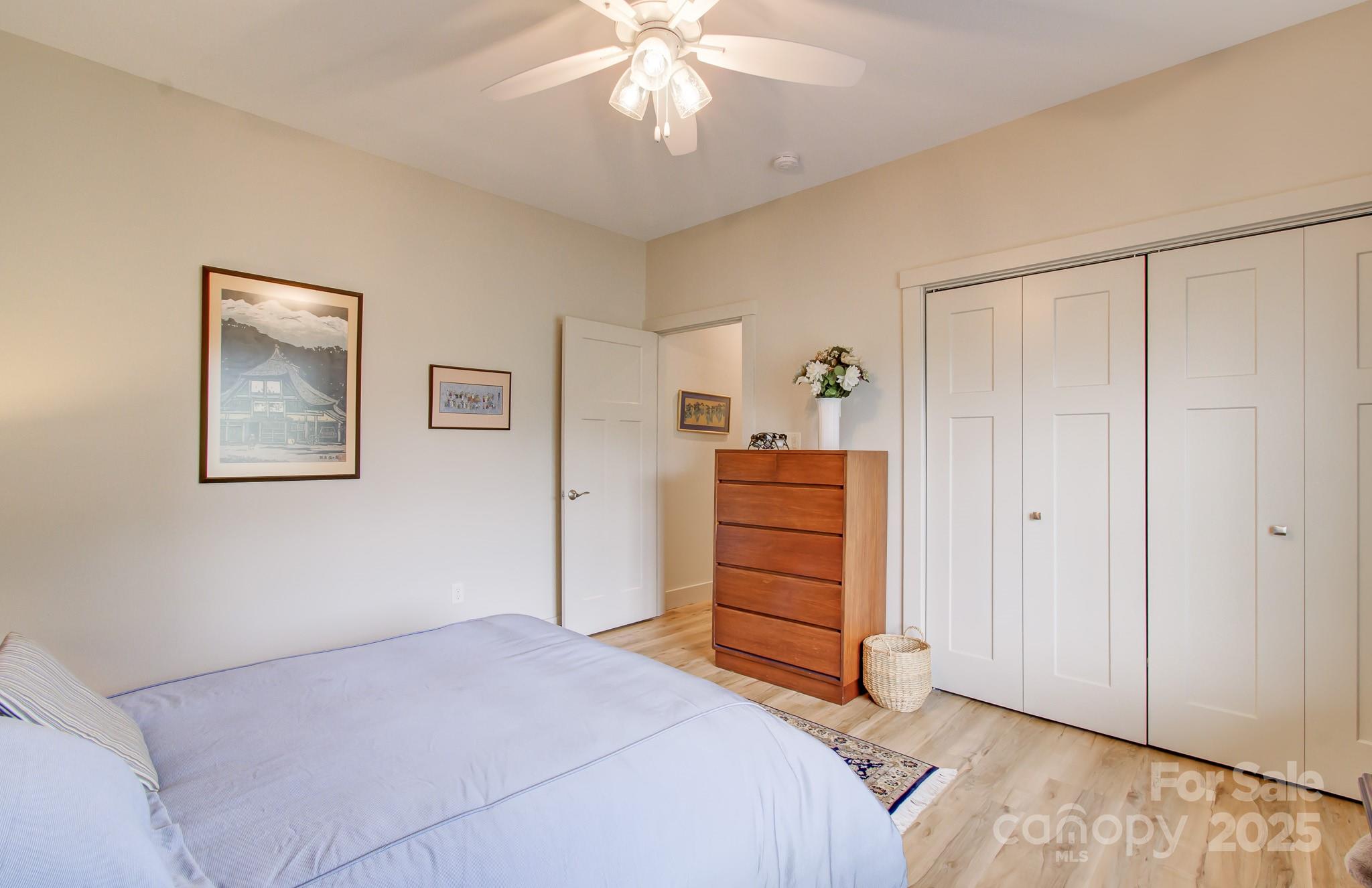 147 Majestic Ridge Road Mills River, NC 28759 - Photo 27 of 48 a bedroom with a bed and a chandelier
