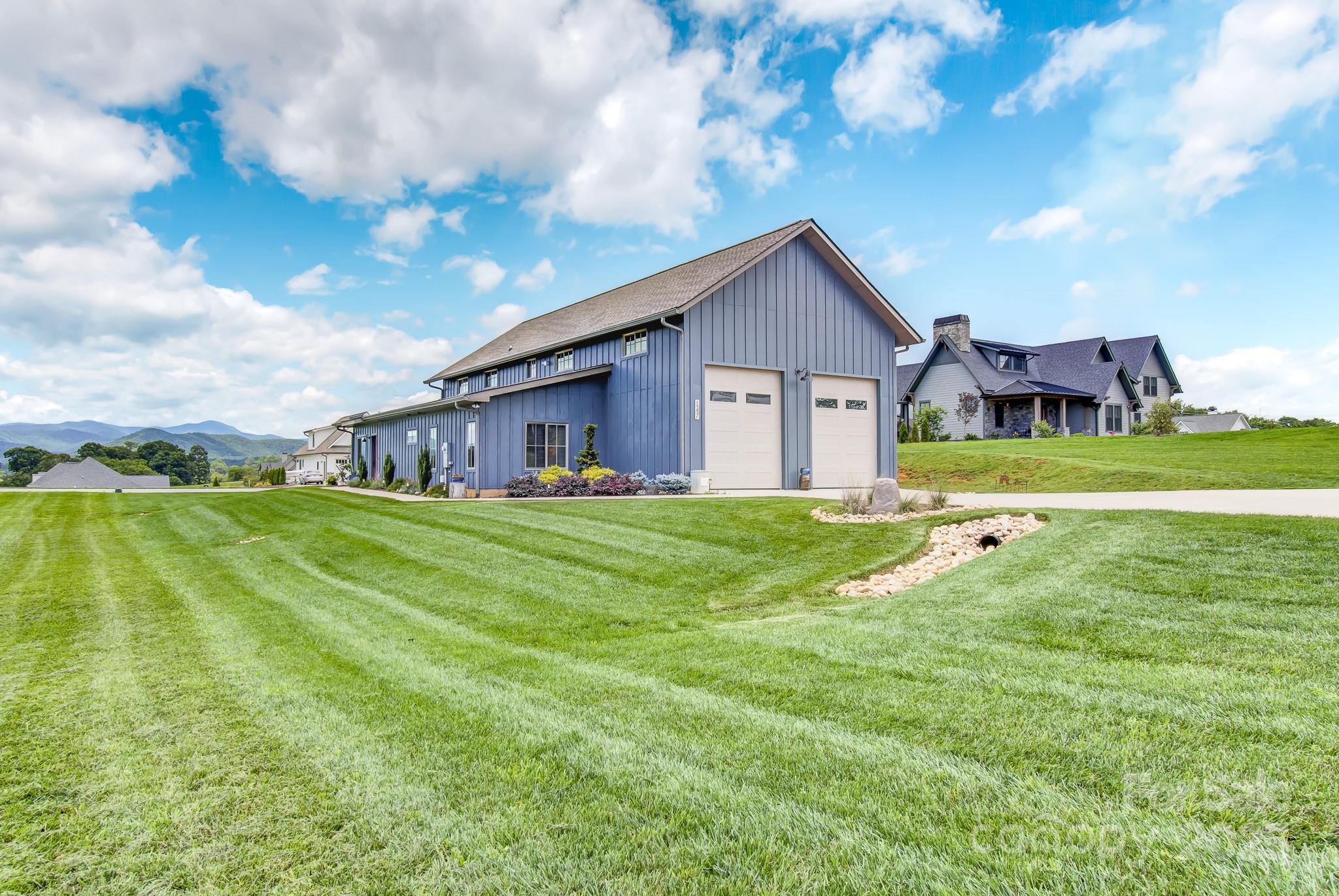147 Majestic Ridge Road Mills River, NC 28759 - Photo 33 of 48 a view of a house with a big yard and large trees