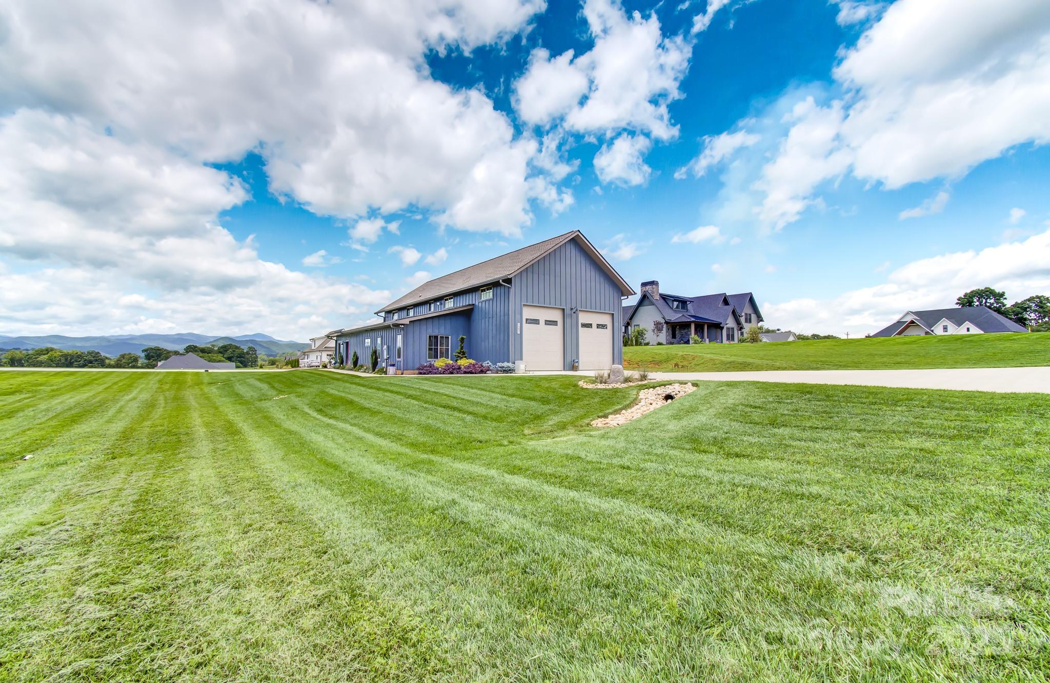 147 Majestic Ridge Road Mills River, NC 28759 - Photo 34 of 48 a house view with swimming pool and garden