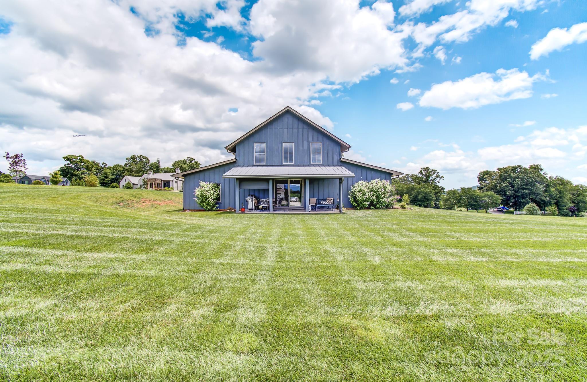 147 Majestic Ridge Road Mills River, NC 28759 - Photo 36 of 48 a front view of house with yard and entertaining space