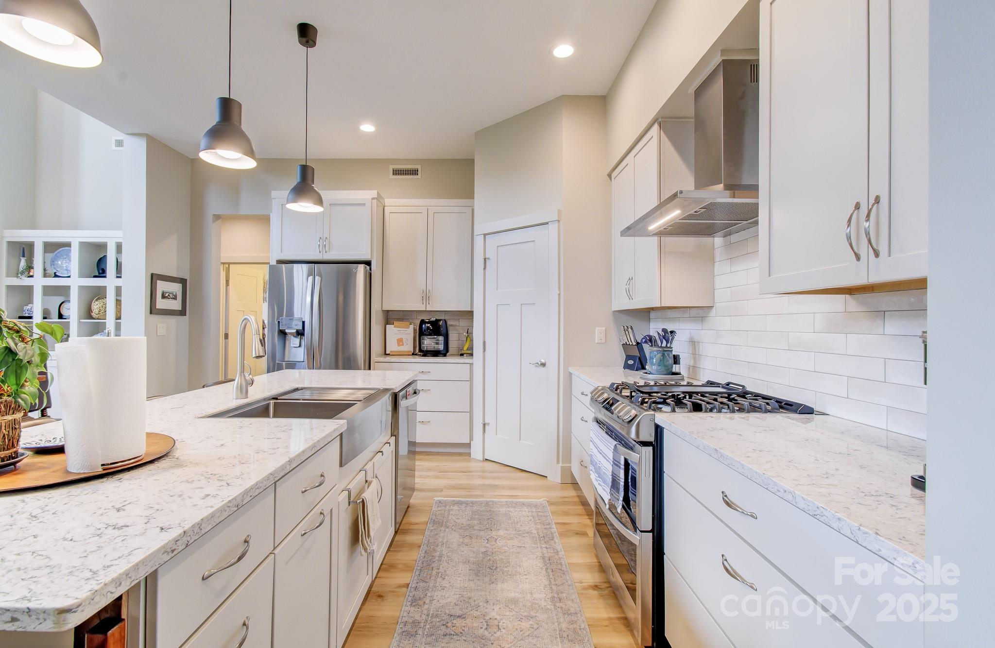 147 Majestic Ridge Road Mills River, NC 28759 - Photo 6 of 48 a kitchen with stainless steel appliances granite countertop a sink stove and refrigerator