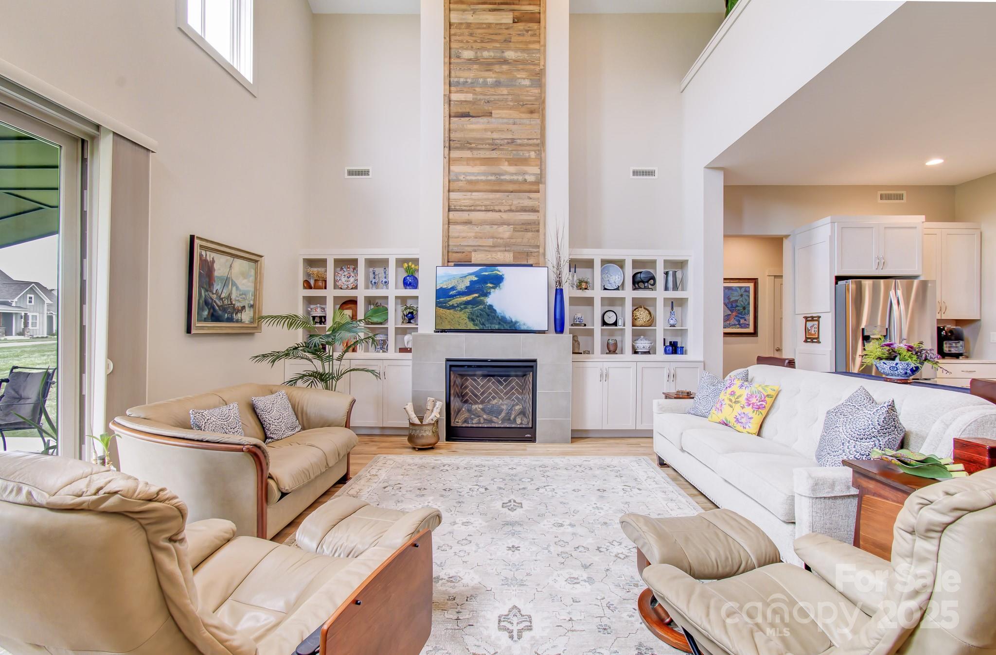 147 Majestic Ridge Road Mills River, NC 28759 - Photo 10 of 48 a living room with furniture and a fireplace