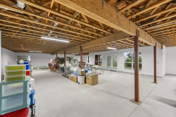a living room with furniture a table and gym equipment