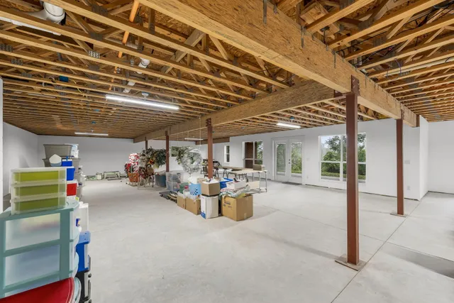 a living room with furniture a table and gym equipment