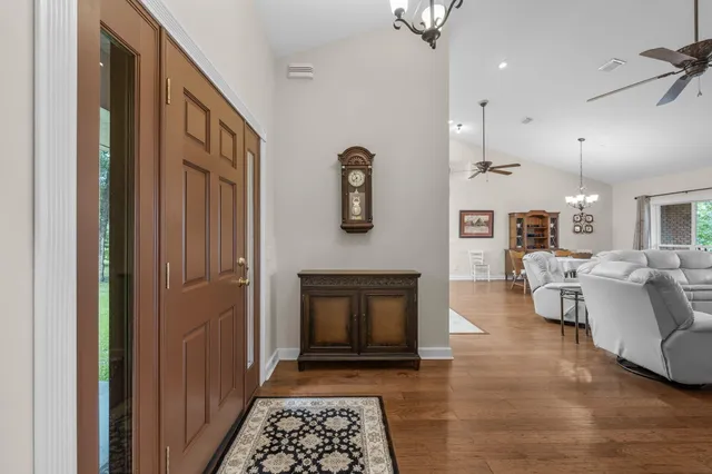 a kitchen with stainless steel appliances granite countertop a stove top oven a refrigerator a sink dishwasher with a dining table and chairs