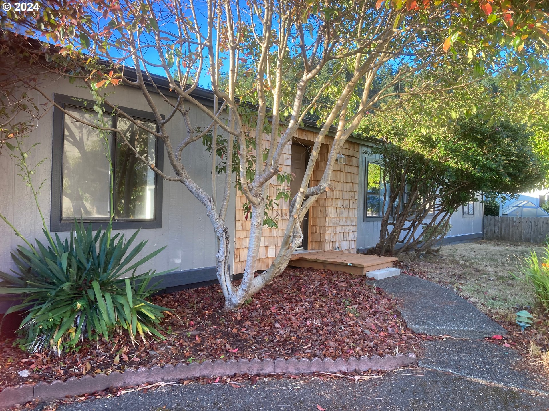100 River Bend Road, Unit 127 Reedsport, OR 97467 - Photo 1 of 21 a view of a house with a tree