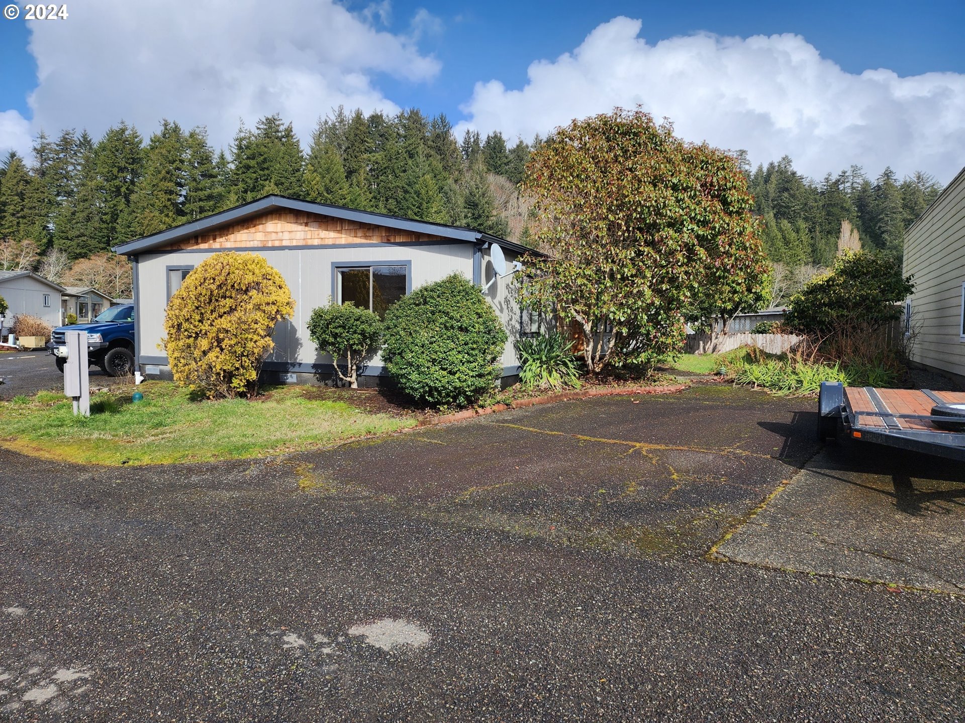 100 River Bend Road, Unit 127 Reedsport, OR 97467 - Photo 14 of 21 a view of a house with backyard and trees