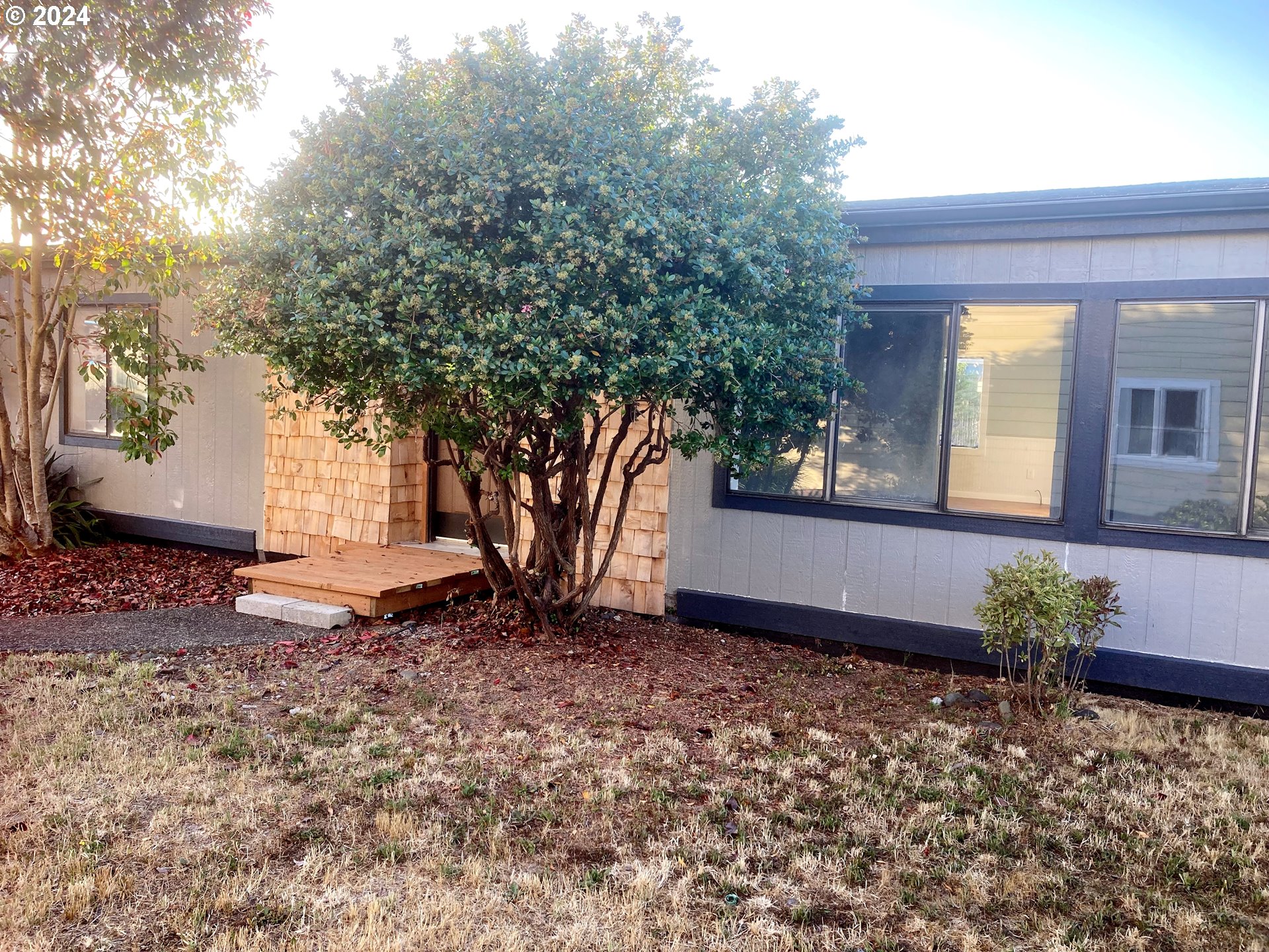 100 River Bend Road, Unit 127 Reedsport, OR 97467 - Photo 2 of 21 a view of a house with a tree