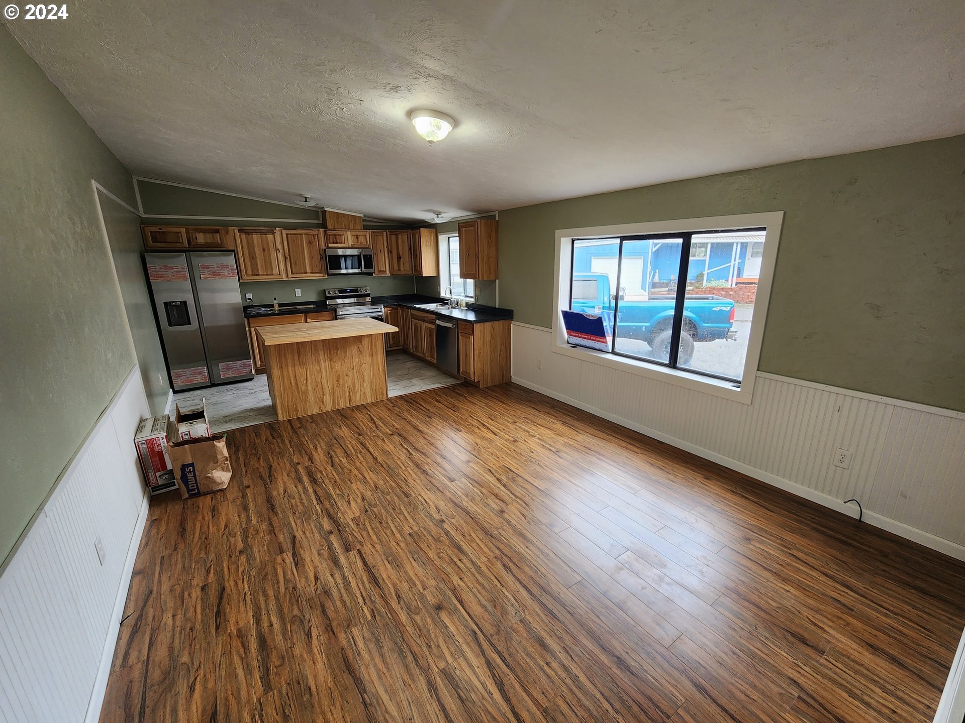 100 River Bend Road, Unit 127 Reedsport, OR 97467 - Photo 3 of 21 a kitchen with a wooden floor and a view of kitchen