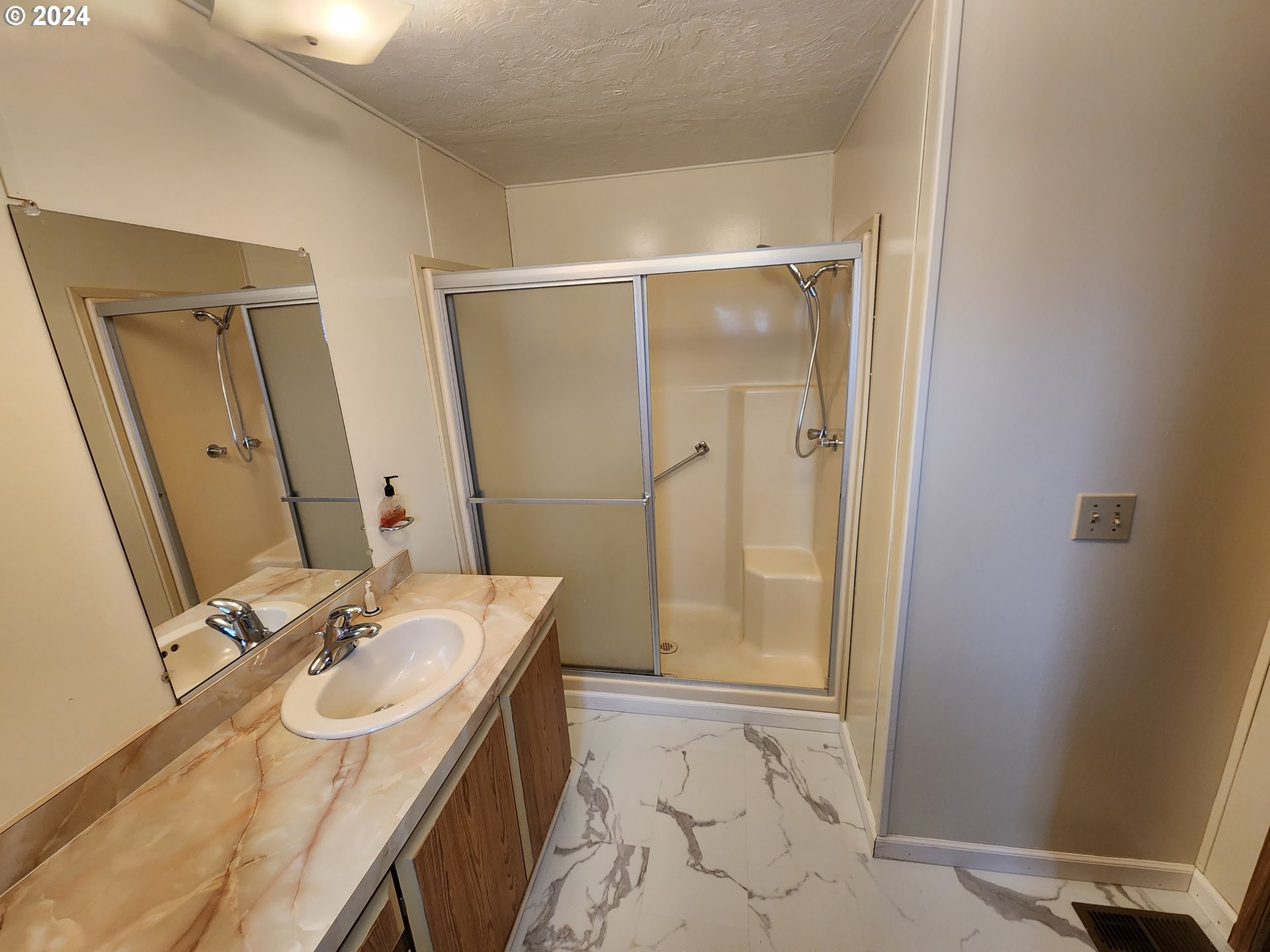 100 River Bend Road, Unit 127 Reedsport, OR 97467 - Photo 8 of 21 a bathroom with a sink a toilet and a mirror