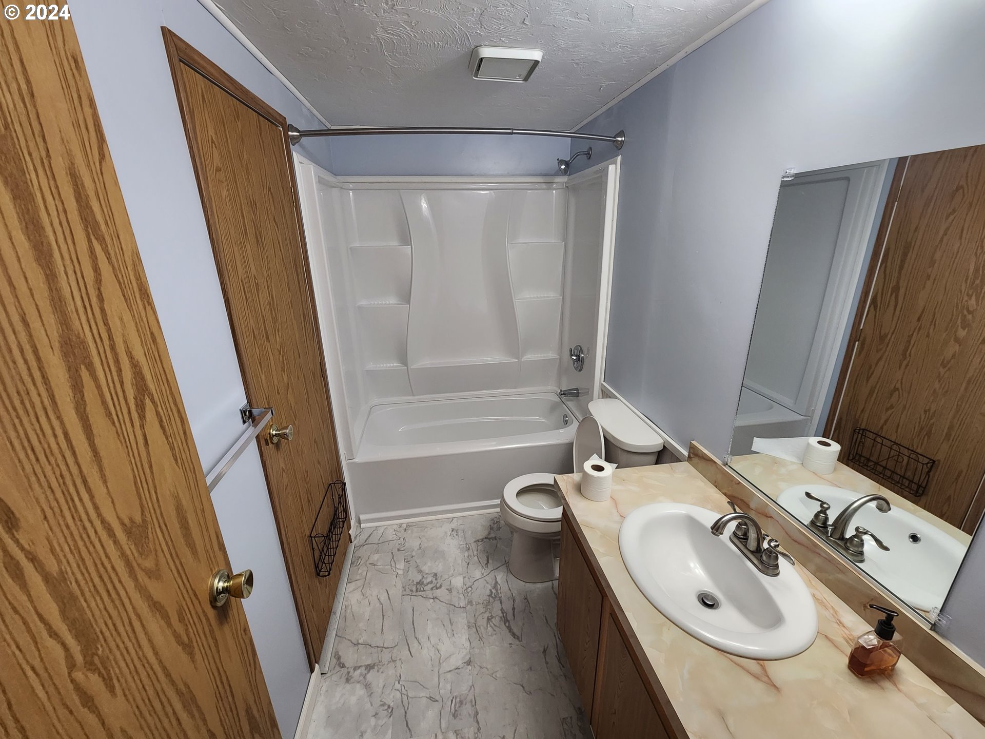 100 River Bend Road, Unit 127 Reedsport, OR 97467 - Photo 9 of 21 a bathroom with a sink a toilet and tub