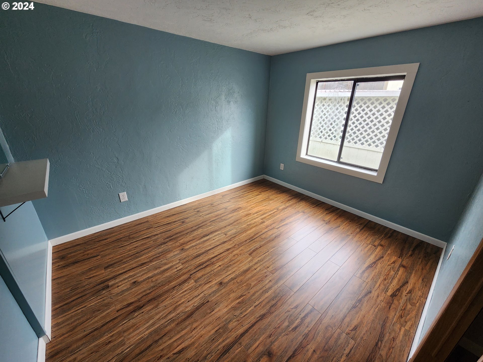 100 River Bend Road, Unit 127 Reedsport, OR 97467 - Photo 10 of 21 a view of an empty room with wooden floor and a window