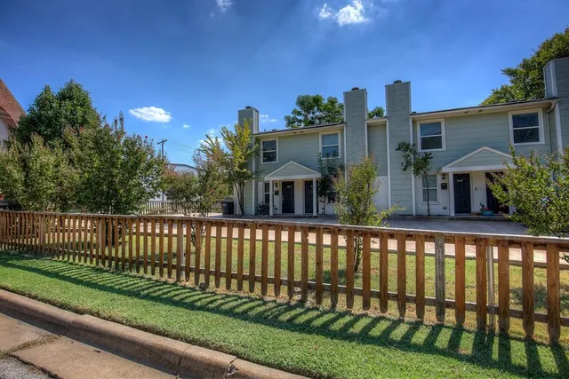 a view of a house with a small yard and a large window
